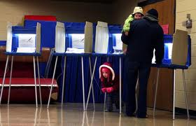 Man with his children at the voting booths.